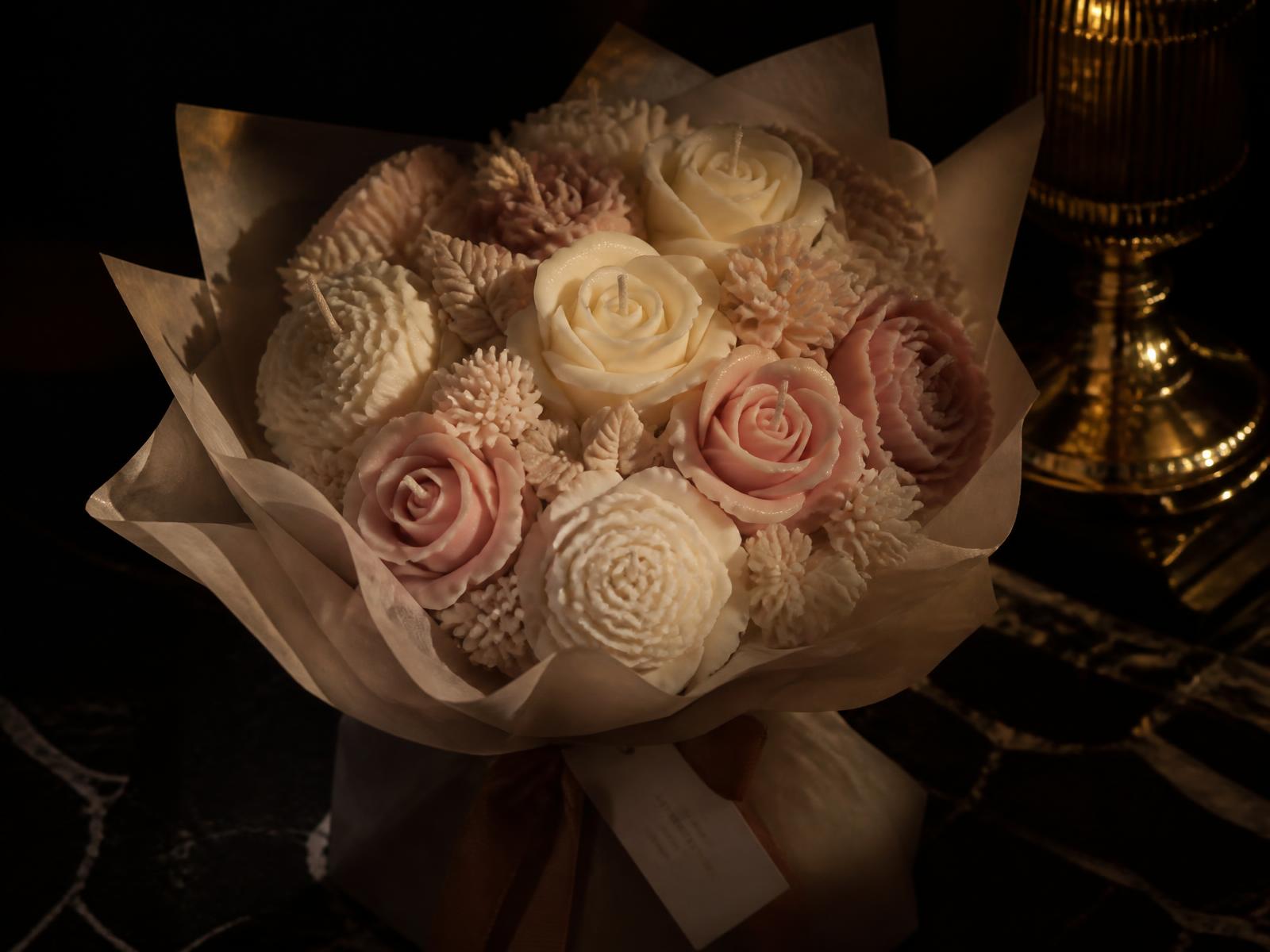 Handmade candle bouquet of cream and blush wax roses wrapped in tissue paper